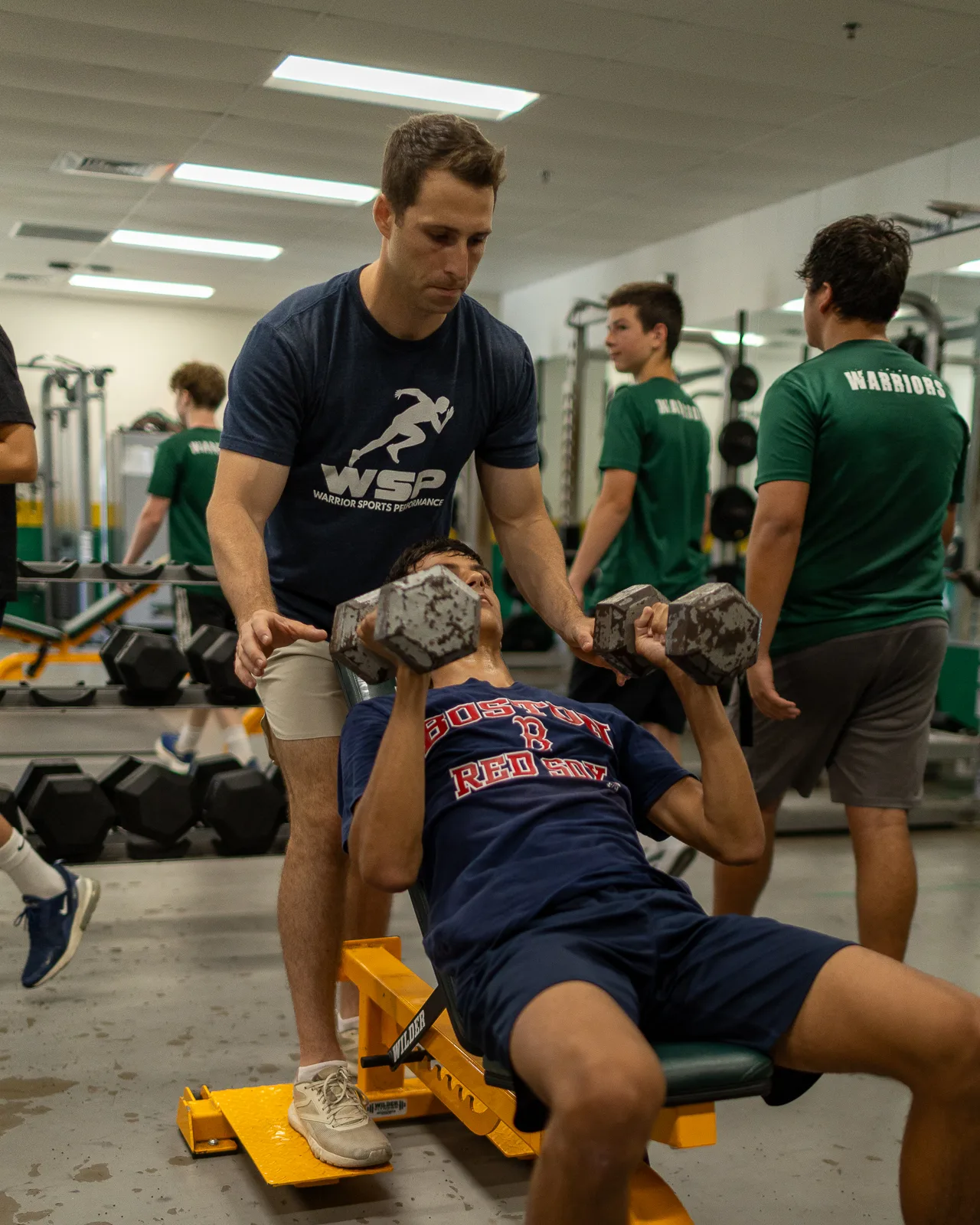 Coach supporting an athlete at the bench