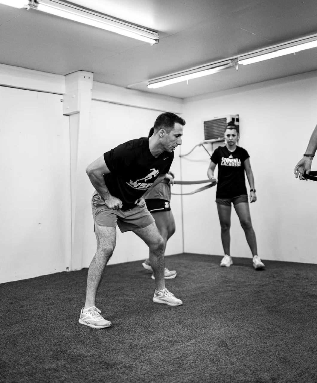 Athlete performing a resisted lateral movement drill with a coach at WSP