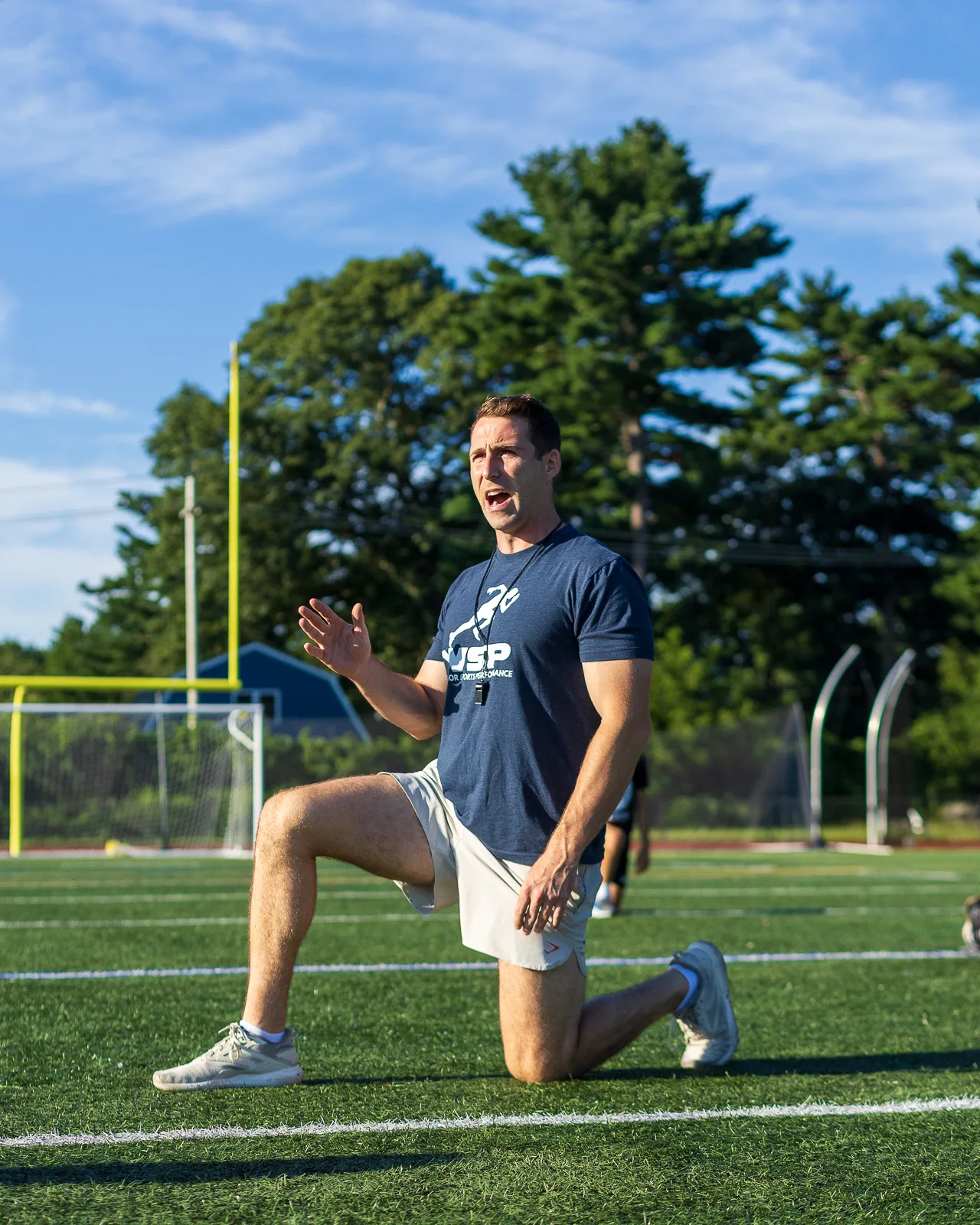 Coach demonstrating movement on the field