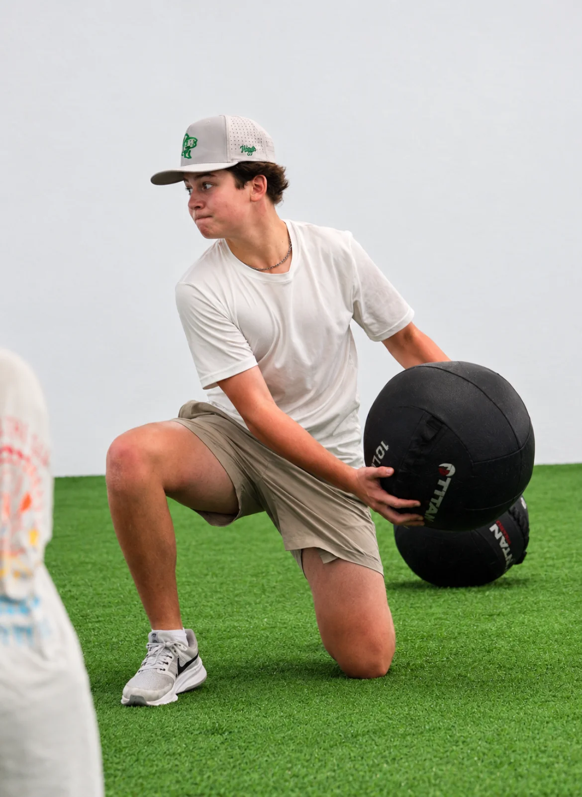 Athlete performing a kneeling medicine-ball exercise at WSP