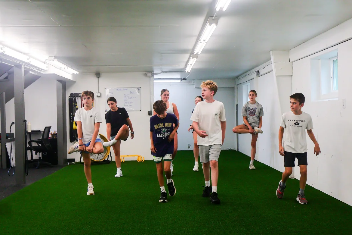 Athletes warming up together on the WSP turf
